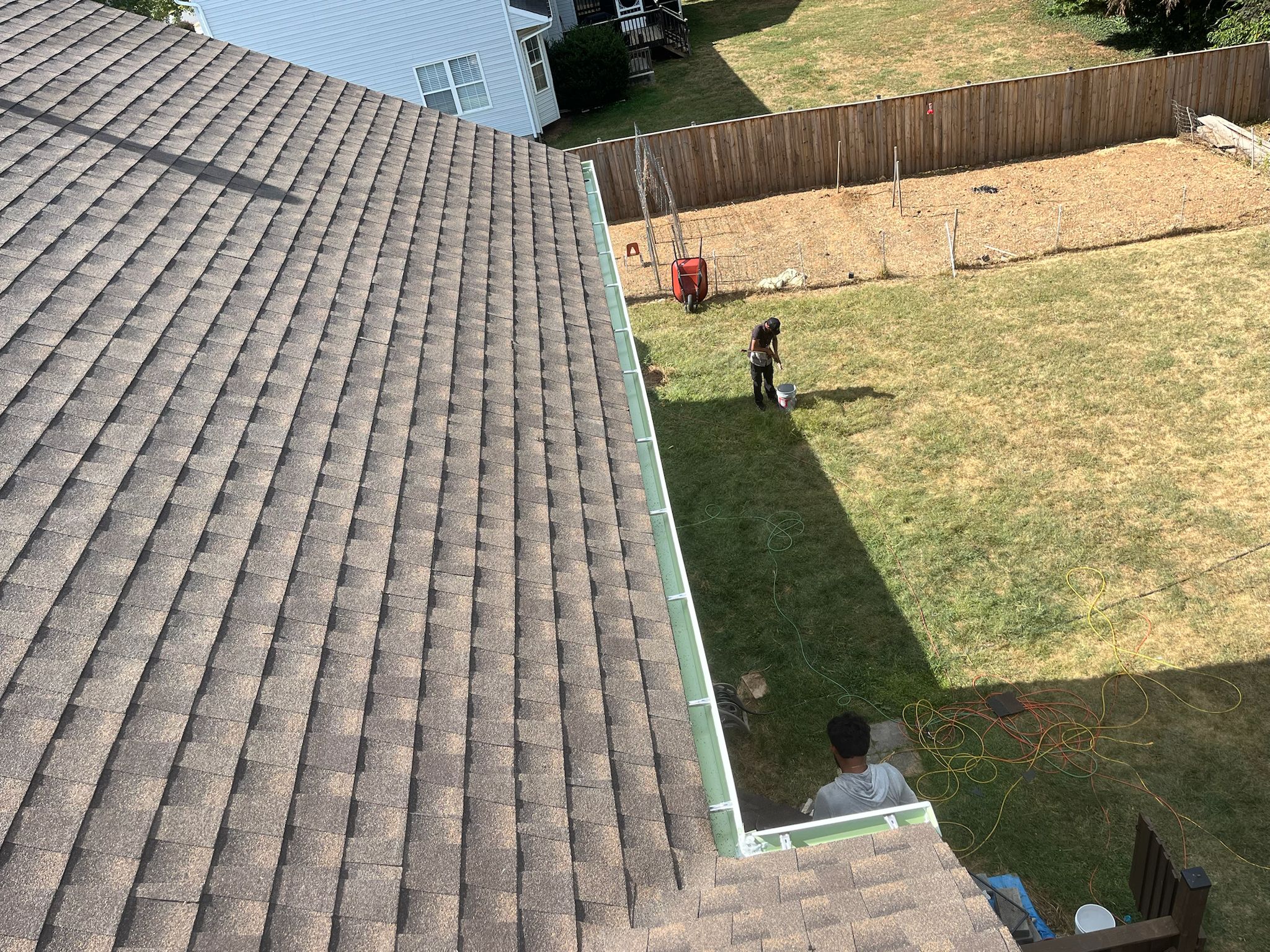 Completed roof installation — crew working on residential home