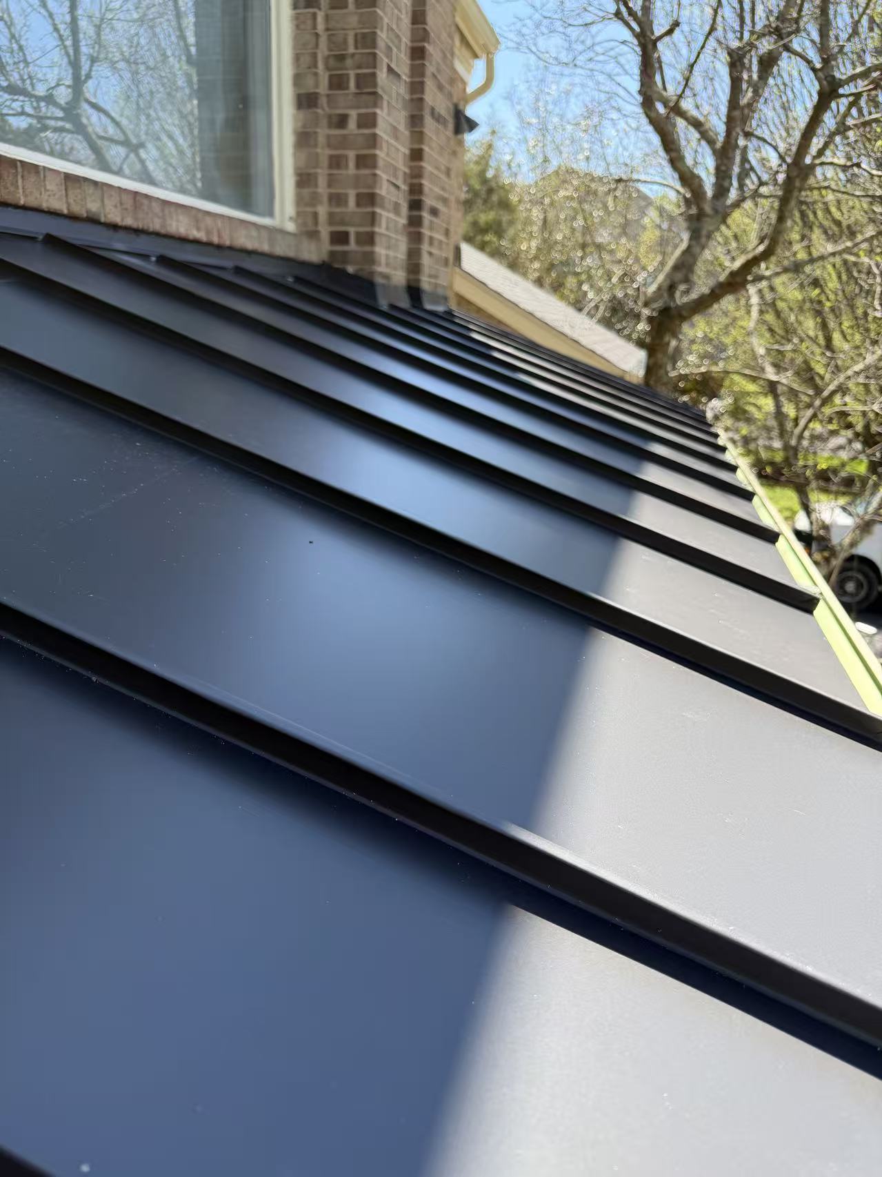 Standing seam metal roof installation close-up