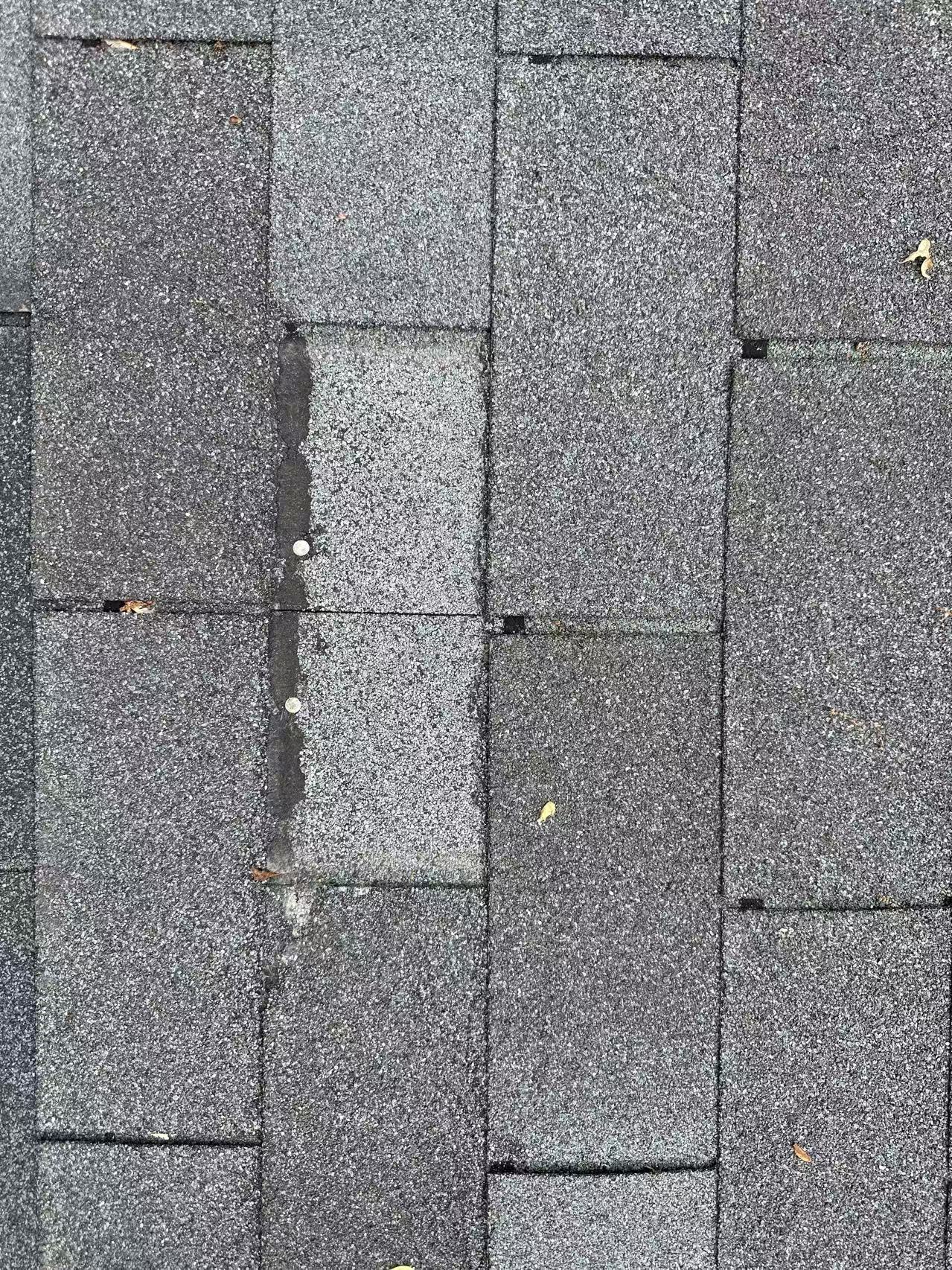 Damaged shingles requiring roof repair