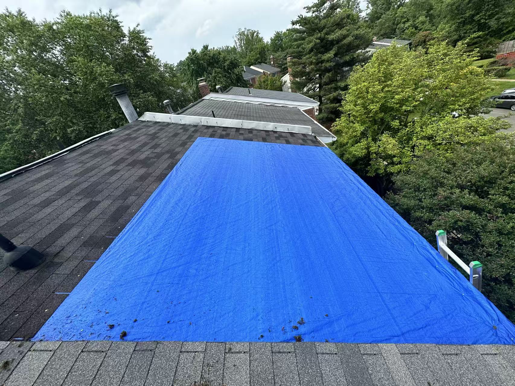 Emergency tarping service — protecting roof after storm damage
